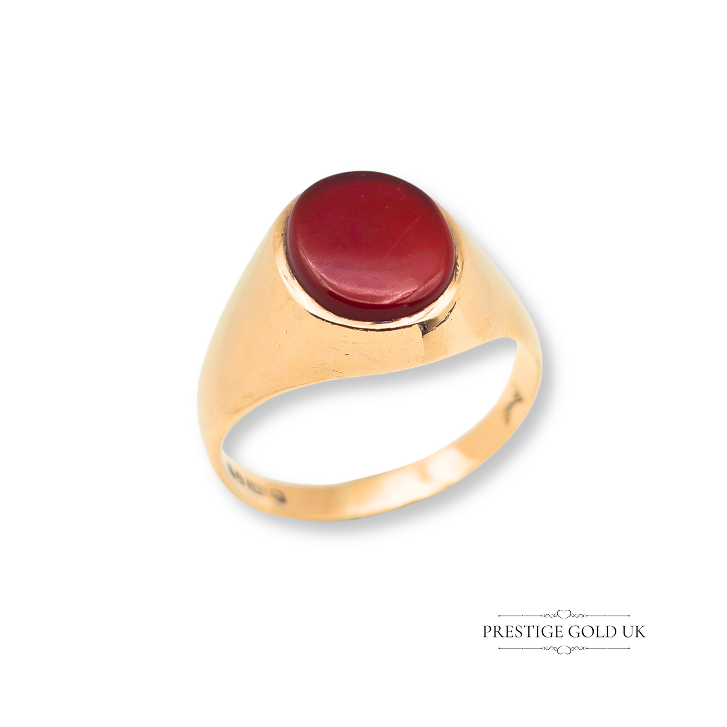 A tiny vintage 9ct gold pinky ring set with an oval red-orange carnelian gemstone in a classic signet style, fully hallmarked London 1975, ideal for retro jewellery lovers and suitable for stacking or wearing alone.