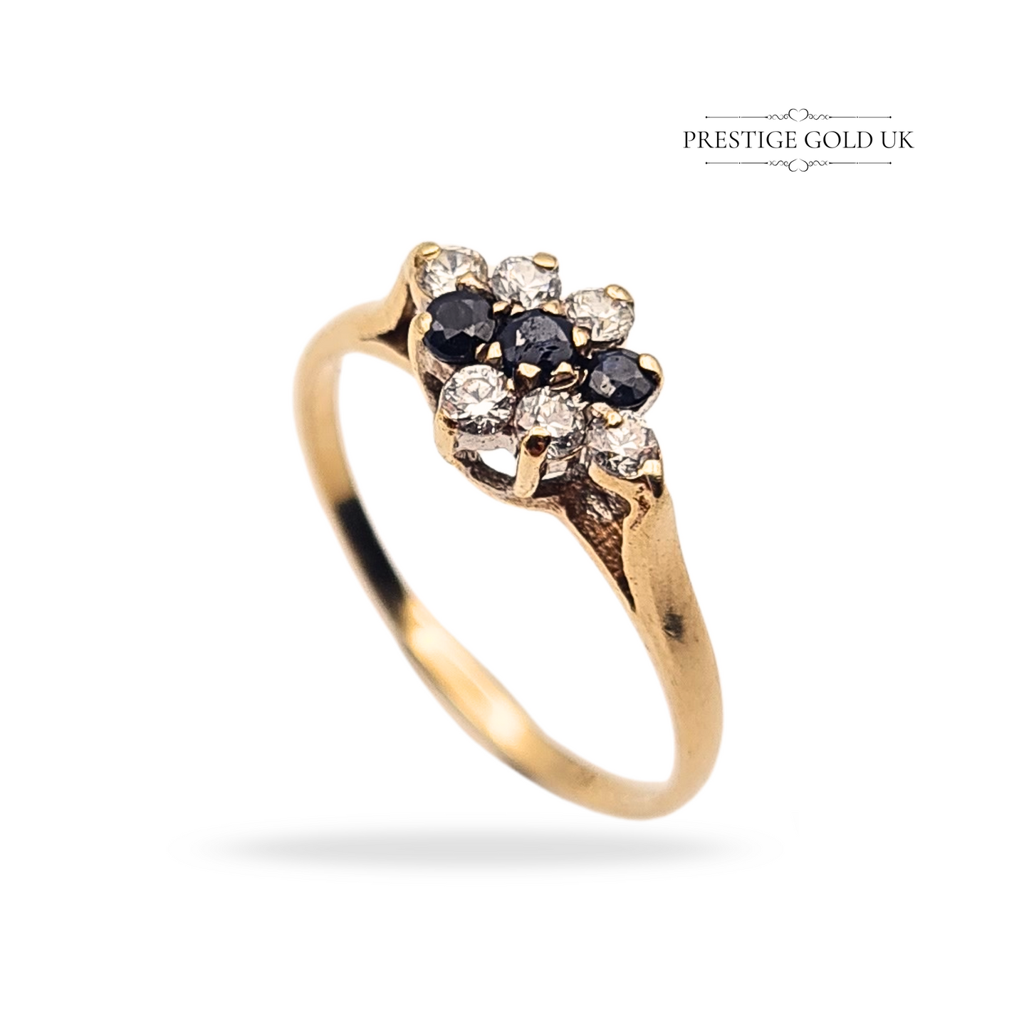 Vintage 9ct gold cluster ring, London 1990 hallmark, featuring 9 alternating sapphires and CZ stones in a dainty 3-row floral setting. Weighs 1.3g, UK size L 1/2 (US 6). Lightweight and feminine with sparkling detail.