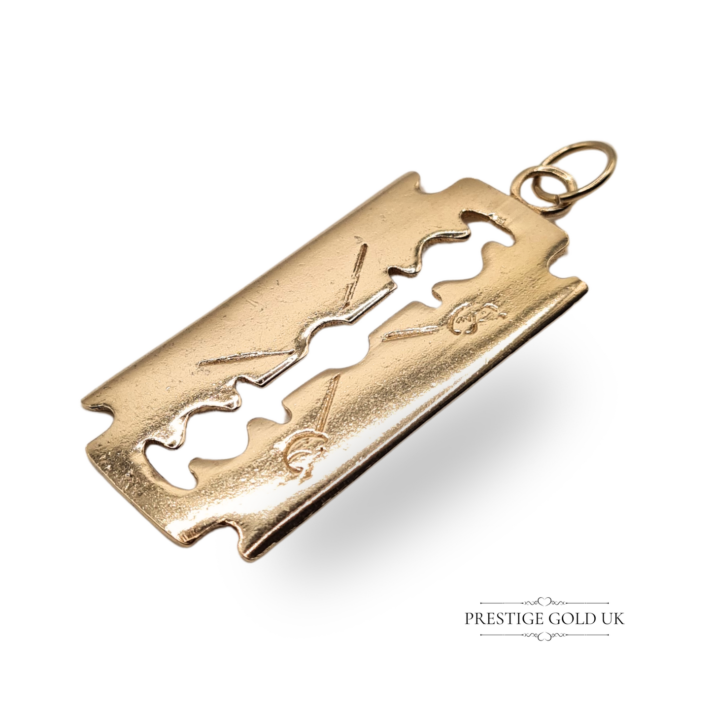 9ct yellow gold pendant shaped like a Wilkinson Sword razorblade, dated 1976, with full London hallmarks and AJ London maker’s mark, bold vintage design