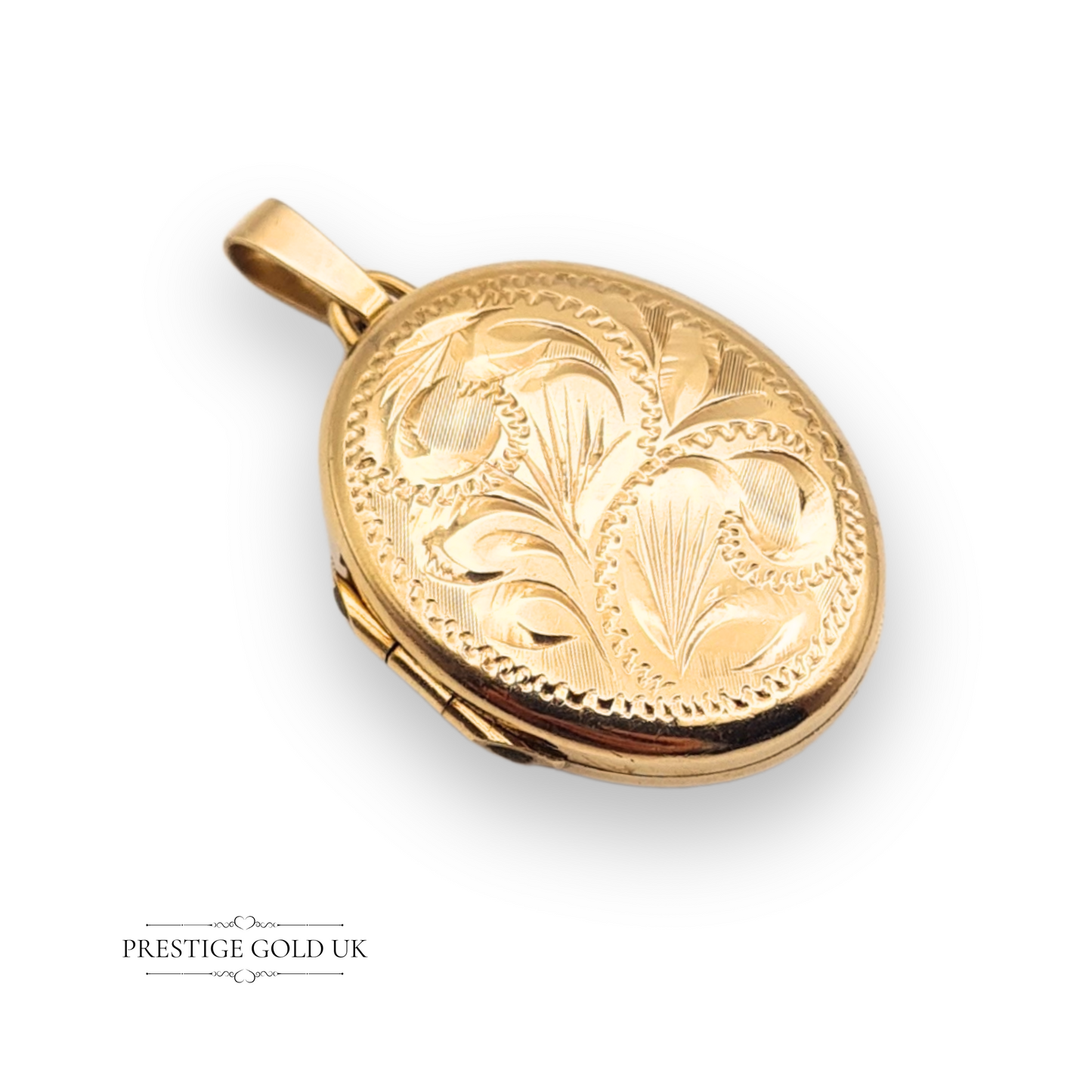 Close-up image of a vintage 9ct gold photo locket with embossed floral detailing, hallmarked by the Birmingham Assay Office, classic oval shape with bail.