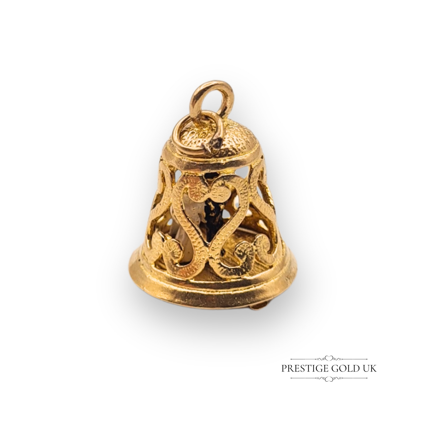 Close-up of a 9ct gold vintage wedding bell charm with ornate cut-out design, opens to reveal enamelled bride and groom, fully hallmarked London.