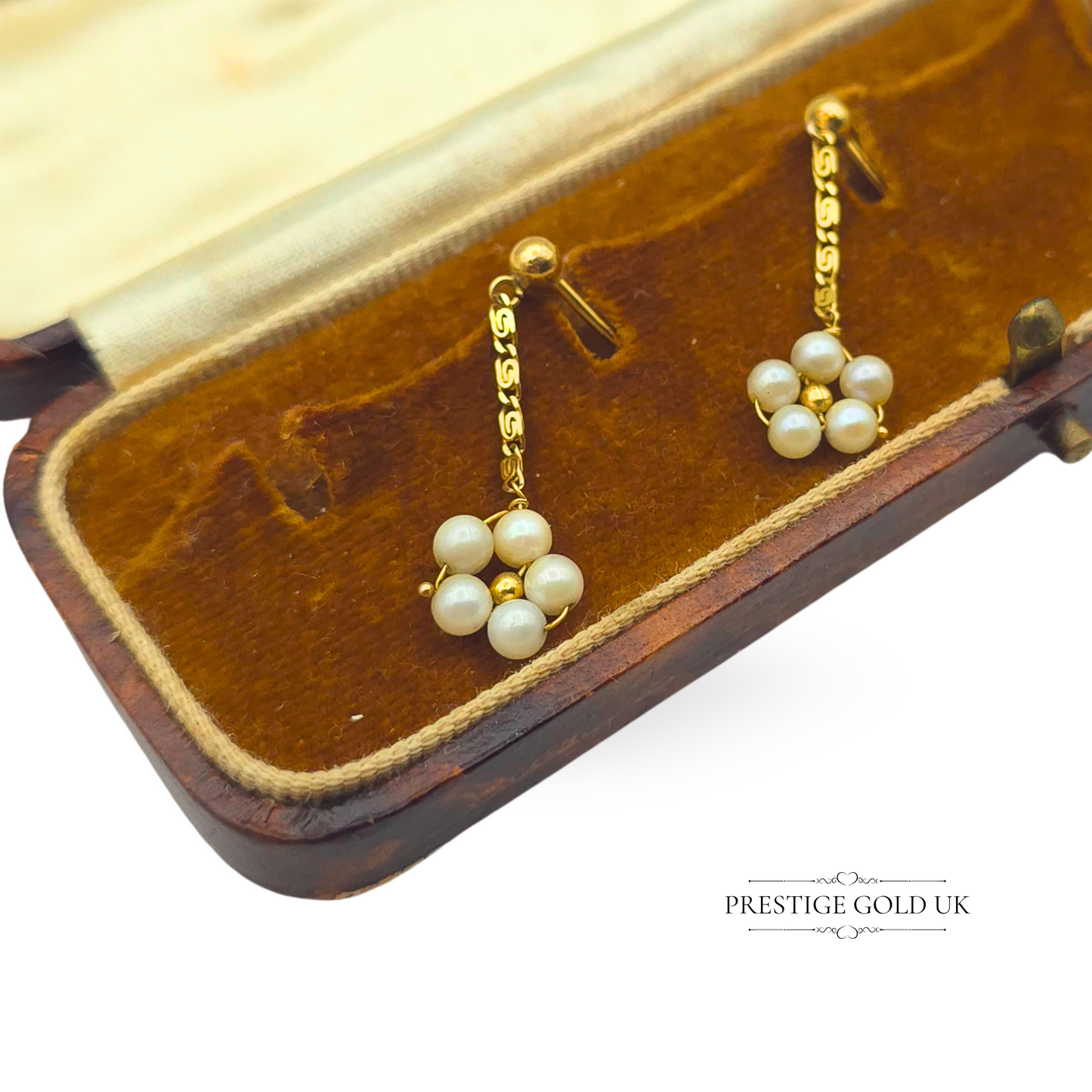 Tiny 9ct gold drop earrings with a 28mm length and 9mm wide floral cluster of cultured pearls. Lightweight at 1.4g, these vintage-style earrings feature an ornate gold drop stem and are tested for gold purity. Dainty and elegant.
