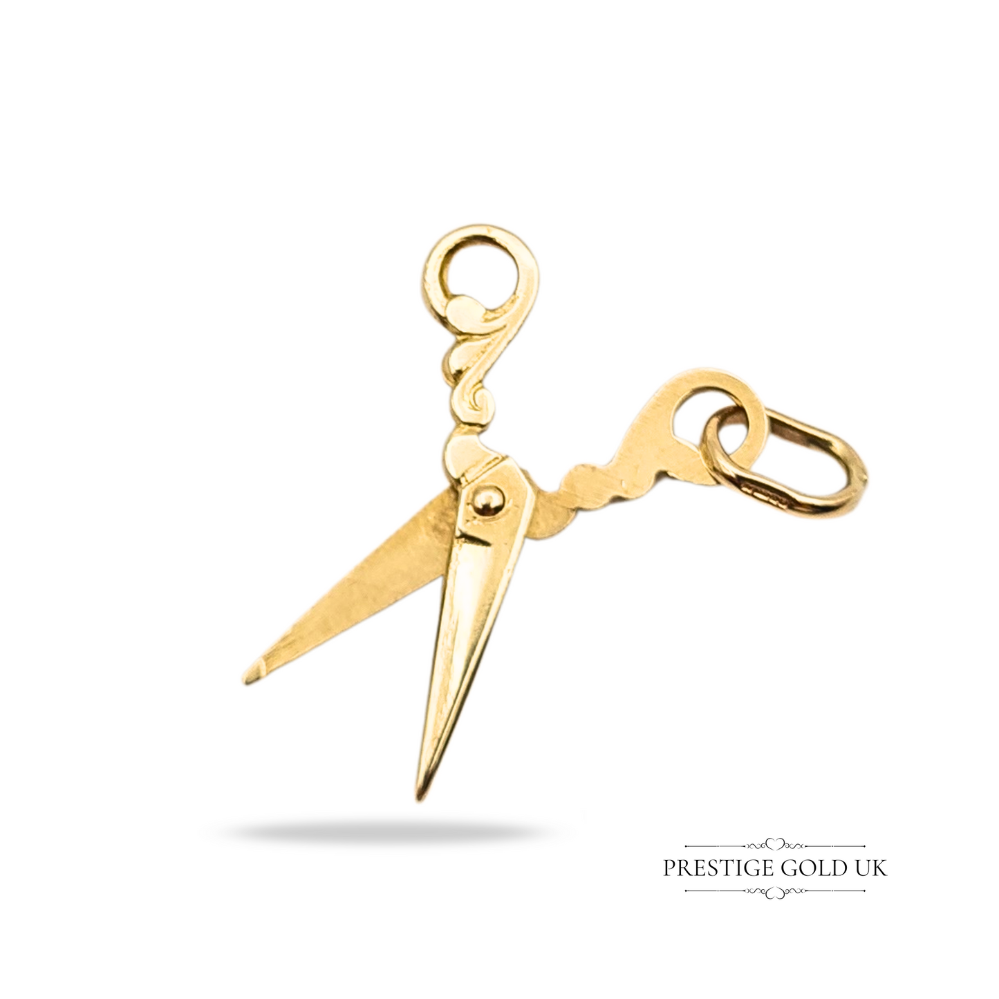 Vintage 9ct gold charm pendant shaped as a pair of ornate opening scissors, fully hallmarked Birmingham 1988, with detailed miniature tool design and polished finish, ideal as a collector’s charm or gift for sewing enthusiasts.