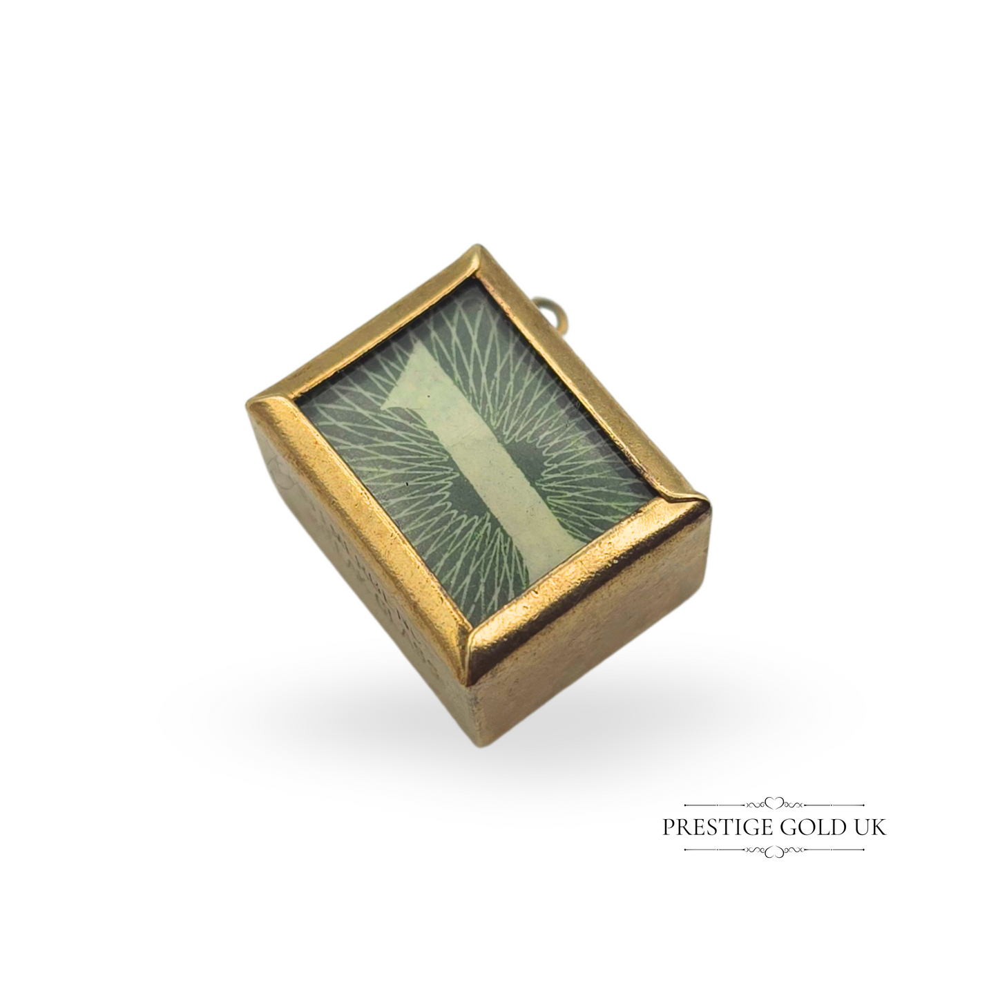 A vintage 9ct gold novelty charm featuring a hidden 1975 British one-pound note inside a glass-fronted case, inscribed "In Emergency Break Glass." Hallmarked for London, this collectible charm weighs 2.5g and measures 15mm long, 12mm deep, and 9mm tall. A unique and fun addition to any charm collection.