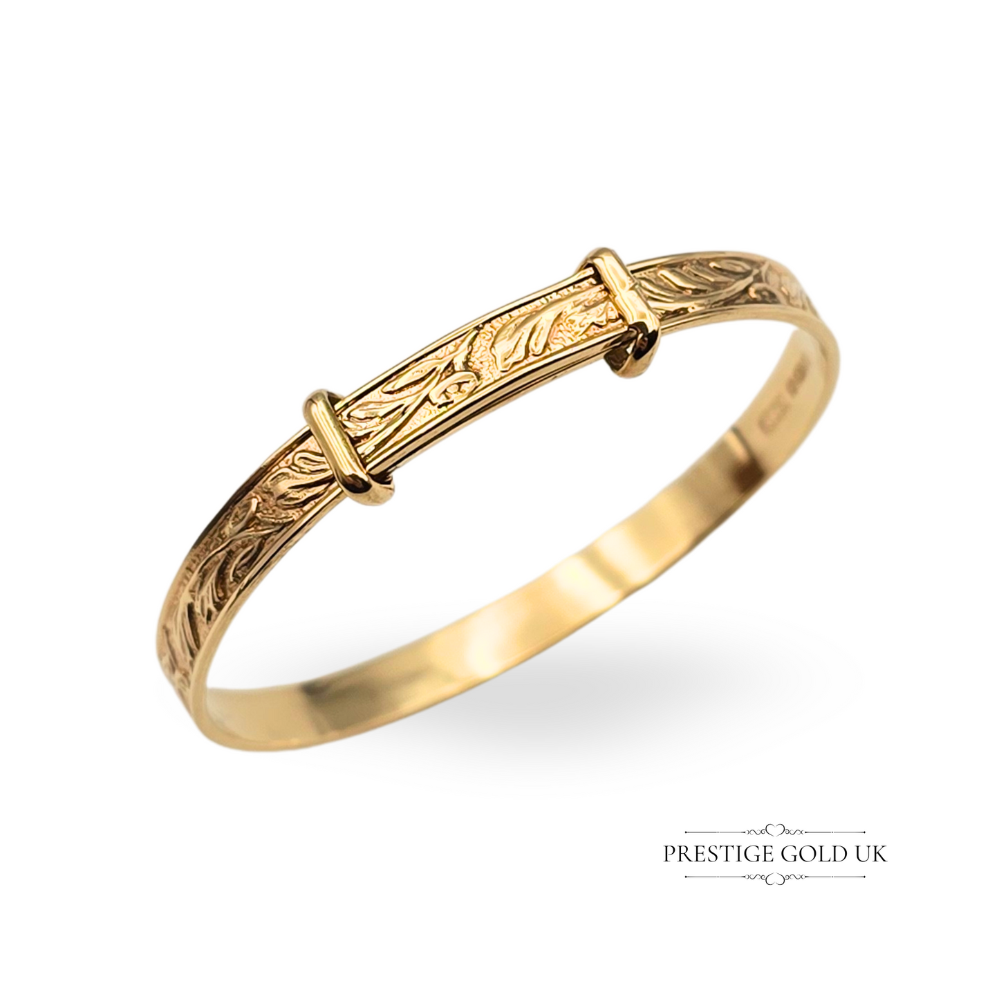 Vintage 9ct gold child’s bangle with elegant botanical engravings and keeper-style detailing, measuring 11cm long, 4mm wide, and weighing 5.2g. Fully hallmarked in Birmingham with 375 stamp, ideal as a timeless gift or heirloom.