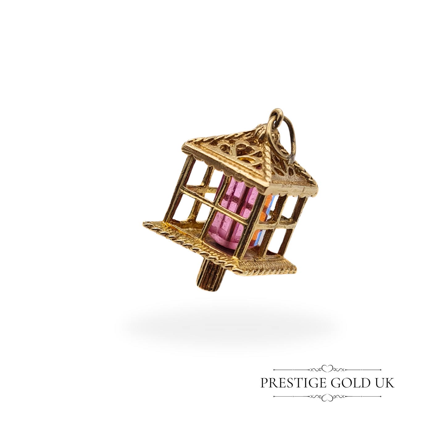 Vintage 9ct gold lantern charm with colourful red and blue glass panels, fully hallmarked London 1972, displayed against a clean white background.
