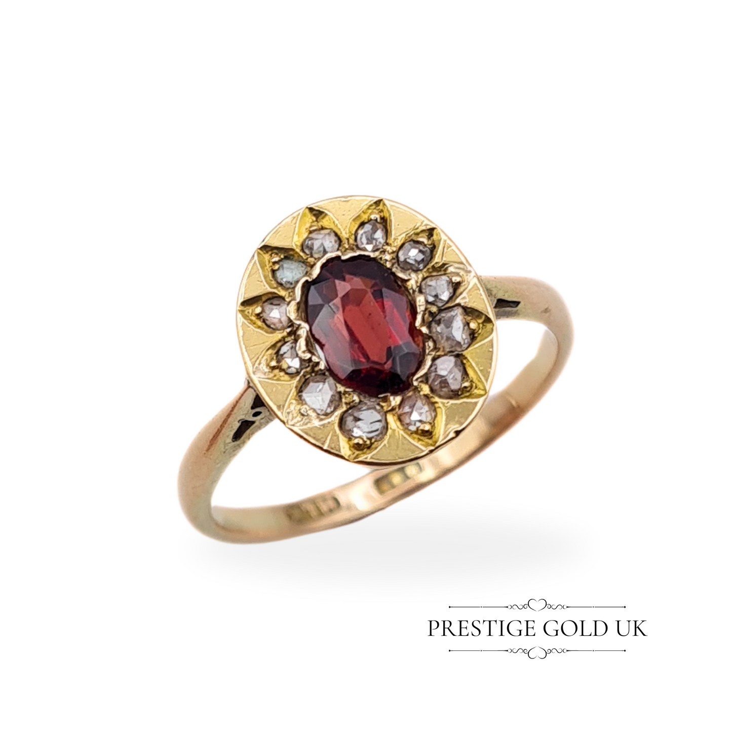 Antique 9ct gold ring featuring an oval garnet centre stone, surrounded by old-cut diamonds in a delicate cluster design.