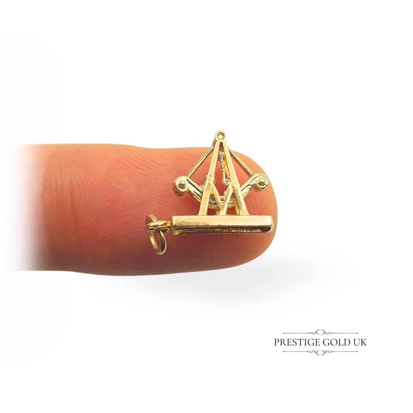 Vintage 9ct gold fun fair ride charm featuring a moving pirate boat seesaw design in yellow and white gold. Fully hallmarked Birmingham 1989, measuring 15mm long. A playful and collectible gold charm, perfect for charm bracelets or as a nostalgic jewellery piece.