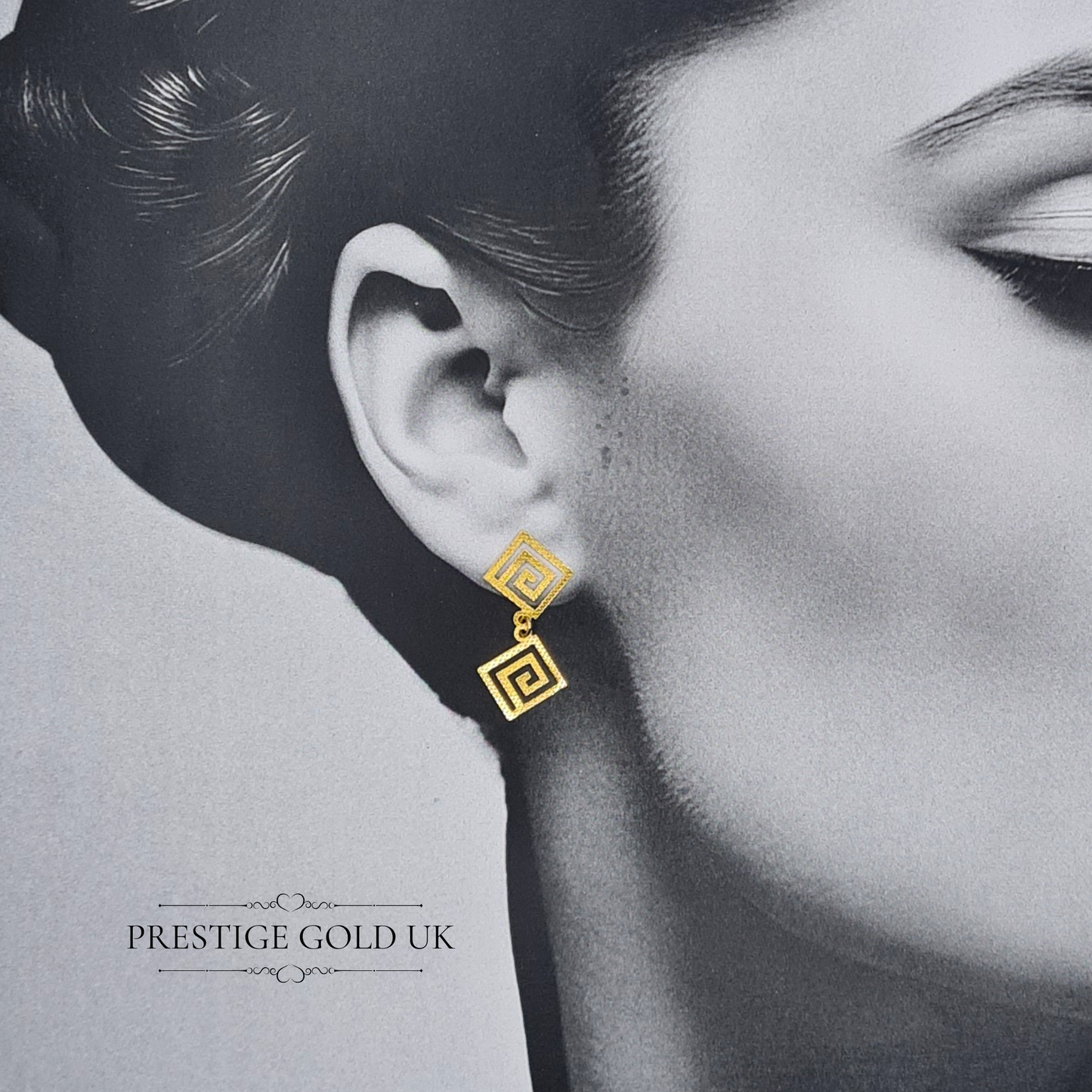 A pair of elegant 14ct gold Greek Key dangle earrings featuring a lightweight geometric design with a 30mm drop. Stamped 585 on the backs,