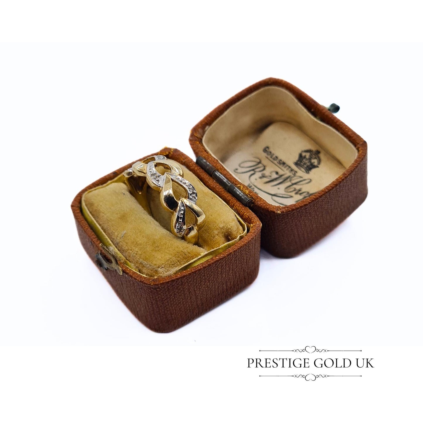 A 1993 British-hallmarked 9ct white and yellow gold ring with interlocking diamond-set hearts and a tapered band, ideal for jewellery lovers and collectors of romantic designs.