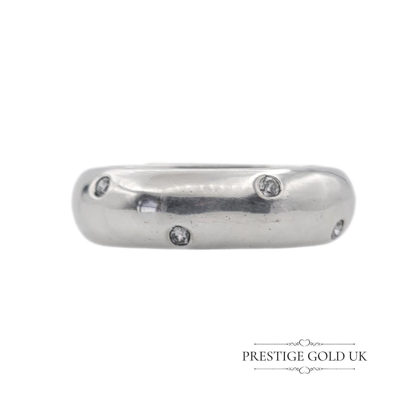 A 6mm wide sterling silver band ring with sparkling white stones, stamped 925 for authenticity. Features a beautiful, eye-catching design. Available in UK size R, US size 8 3/4, and Euro size 59. f sparkle to any outfit.
