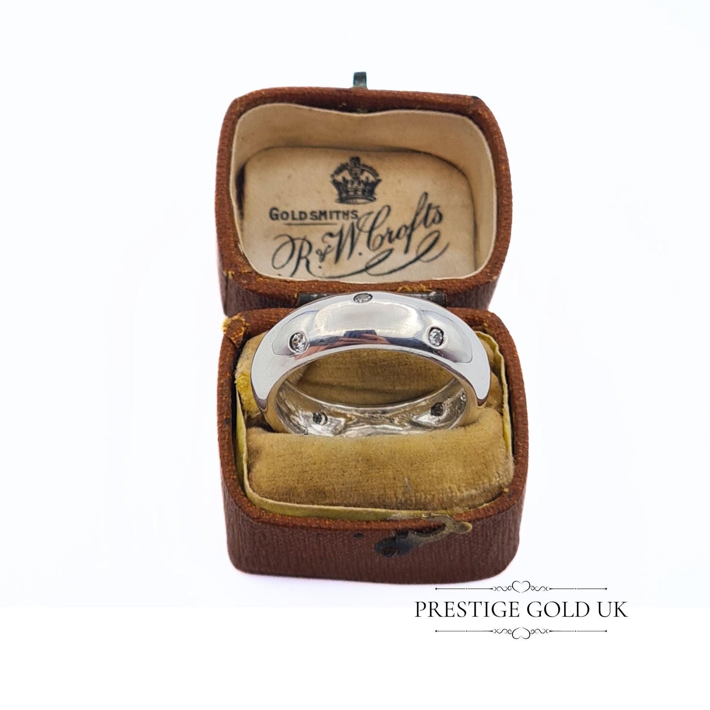 A 6mm wide sterling silver band ring with sparkling white stones, stamped 925 for authenticity. Features a beautiful, eye-catching design. Available in UK size R, US size 8 3/4, and Euro size 59. f sparkle to any outfit.