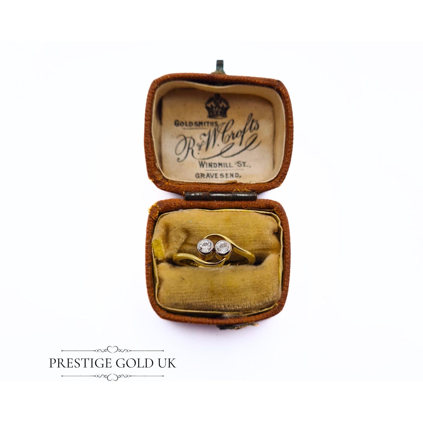 18ct gold crossover ring featuring two 0.03-carat diamonds, size UK I, with a stamped 18K hallmark and 2.6 grams weight. Elegant design with delicate diamond accents, perfect for a refined, sophisticated look.