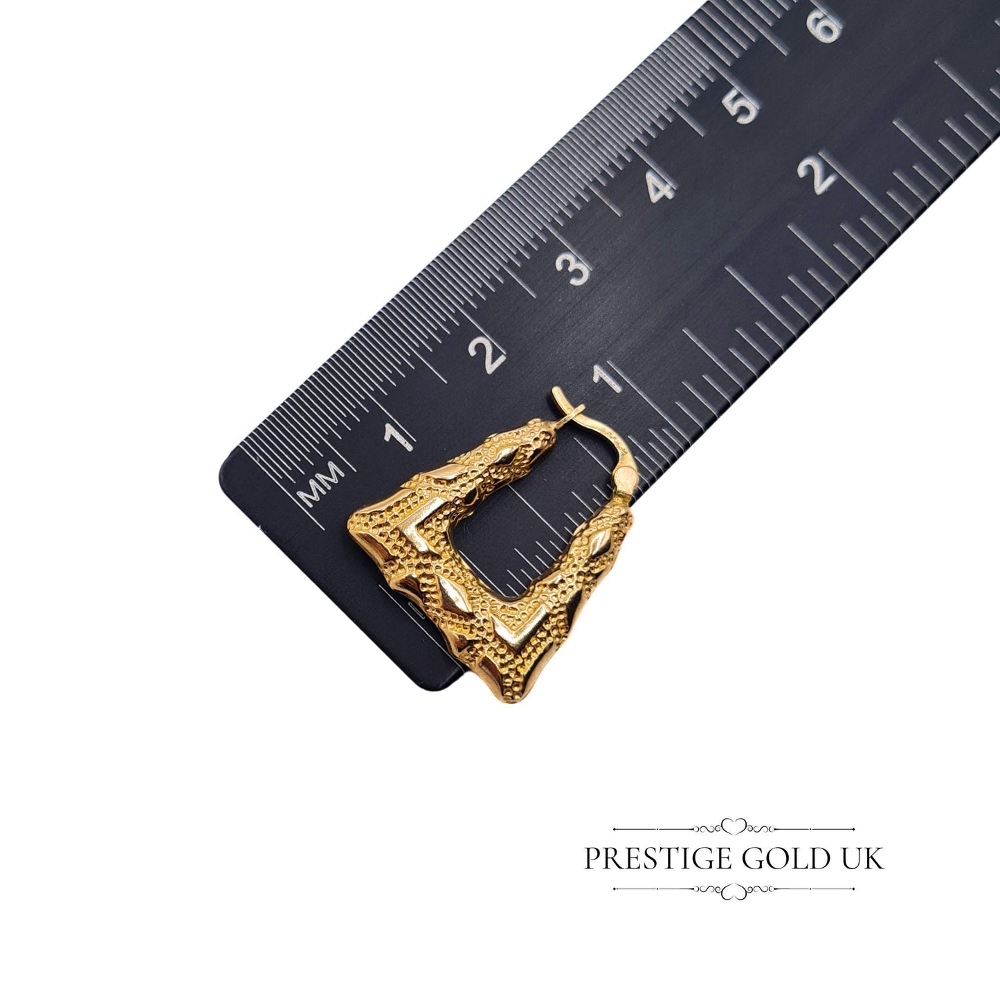 Artistic shot of vintage textured gold hoops on a stylised display, emphasising their bold openwork pattern and unique geometric form.