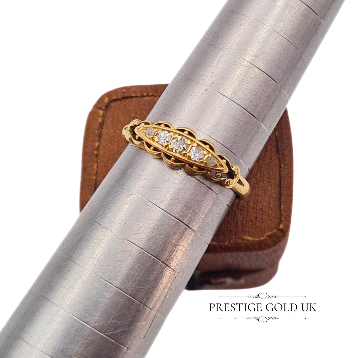 Close-up of an 18ct gold Georgian ring showcasing intricate gallery work and sparkling old-cut diamonds.