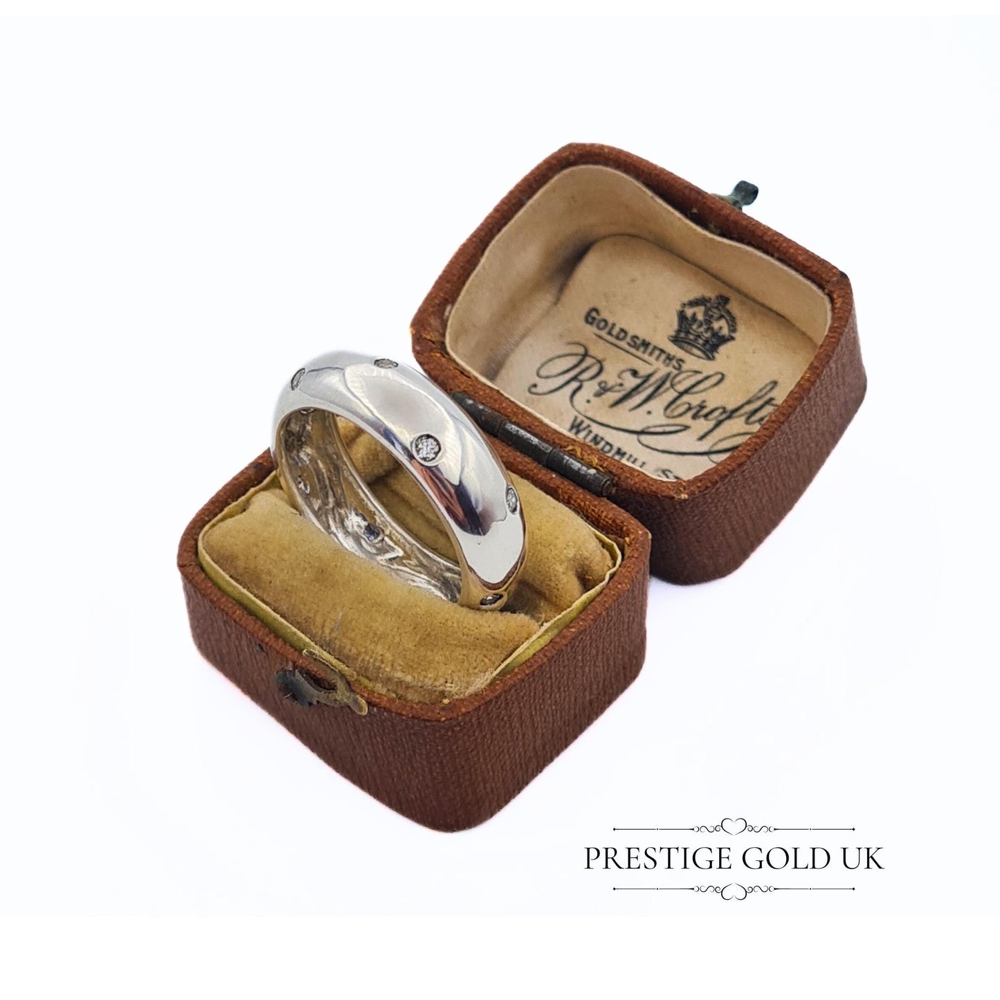 A 6mm wide sterling silver band ring with sparkling white stones, stamped 925 for authenticity. Features a beautiful, eye-catching design. Available in UK size R, US size 8 3/4, and Euro size 59. f sparkle to any outfit.