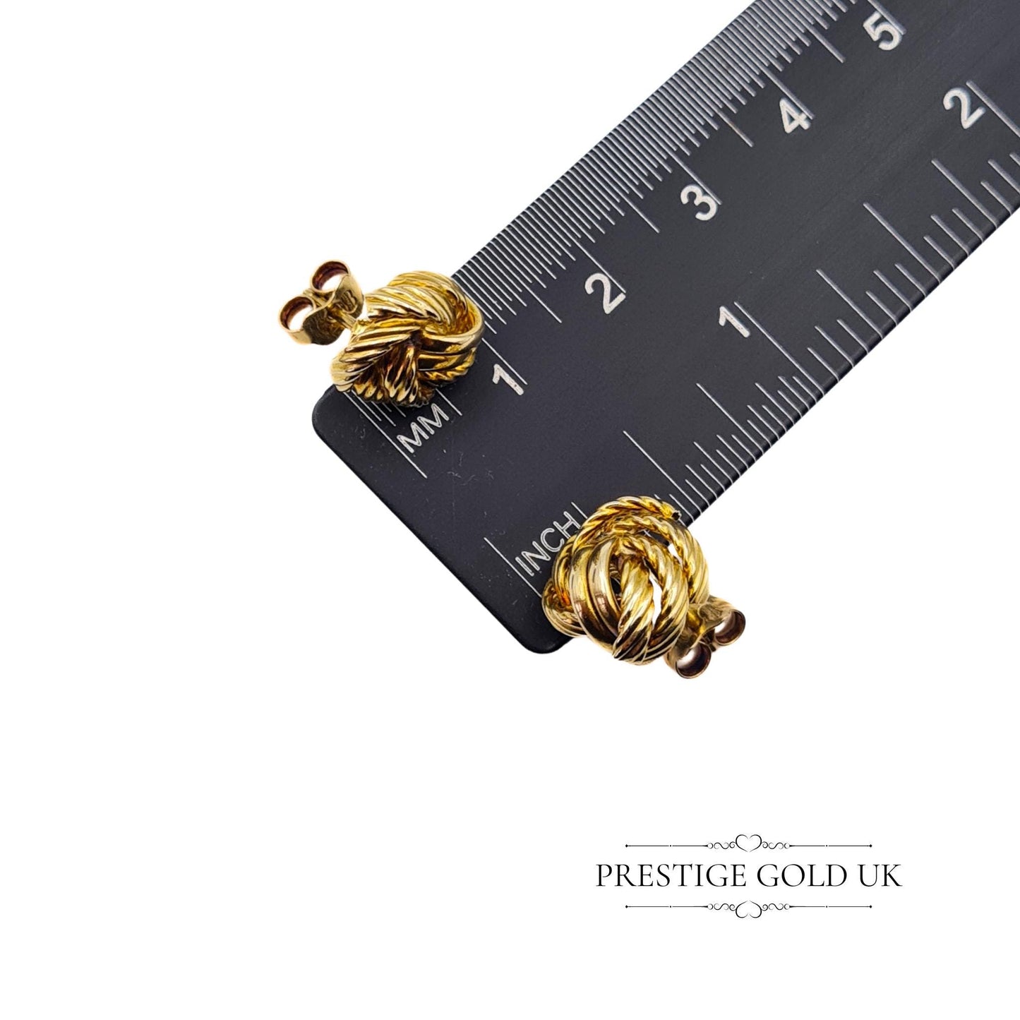 Side-by-side comparison of the earrings with a ruler, verifying their 12mm face width.