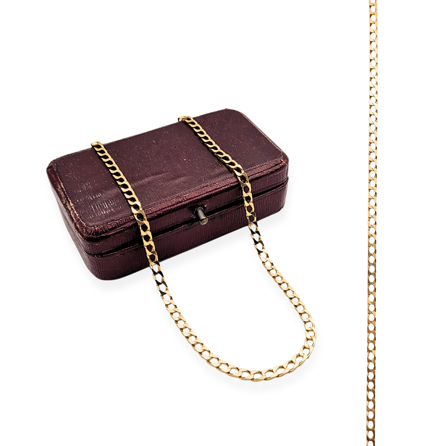 Close-up of a 9ct solid gold flat curb chain necklace with British hallmarks, 26 inches (66 cm) long and 2.7 mm wide, featuring a polished finish and secure spring ring clasp; sleek unisex design displayed against a neutral background.