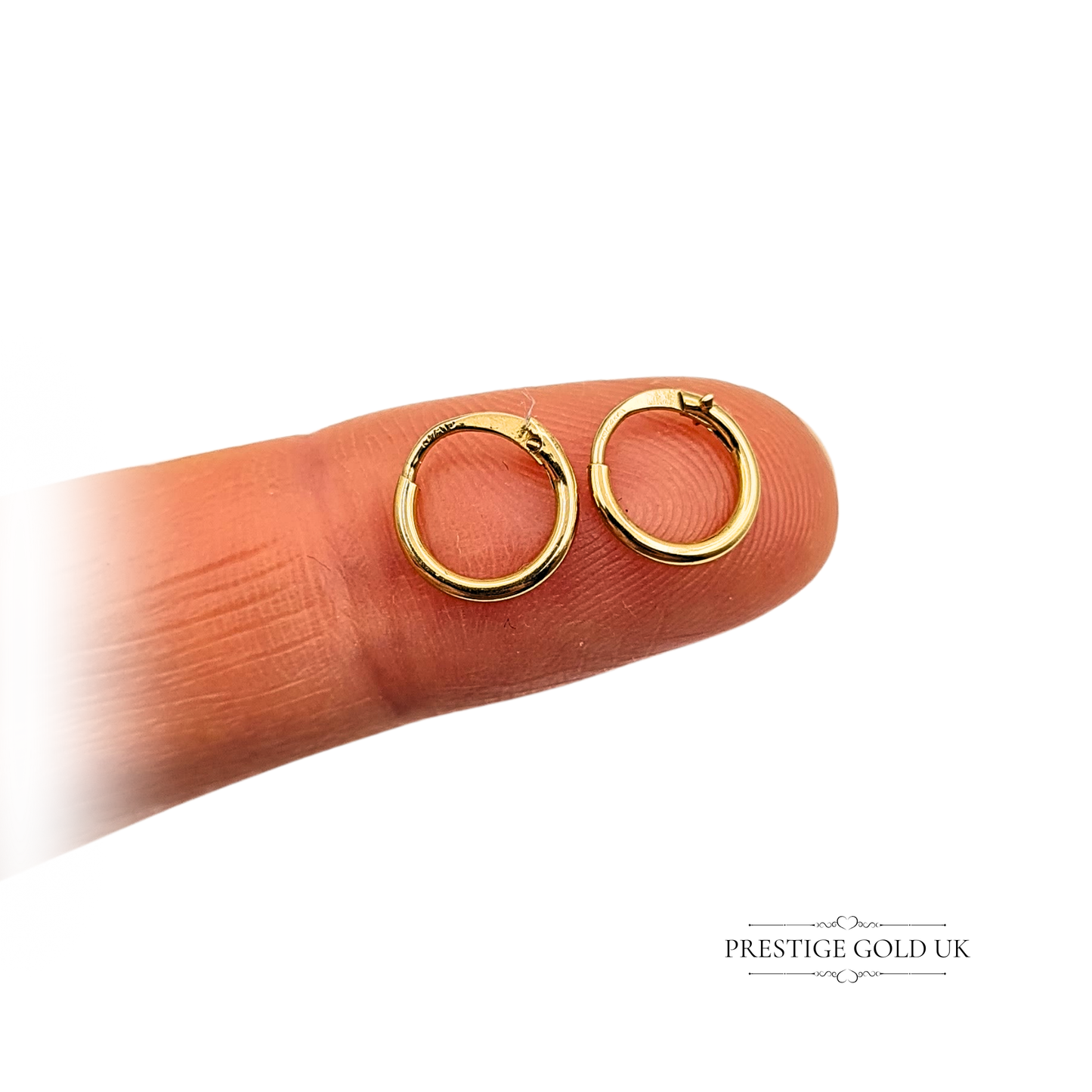 Pair of miniature 18ct gold hinged sleeper hoop earrings, fully tested for gold purity, measuring 8mm in diameter and weighing 0.22g, with polished finish and secure snap clasp, elegant minimalist design ideal for daily wear or second piercings.
