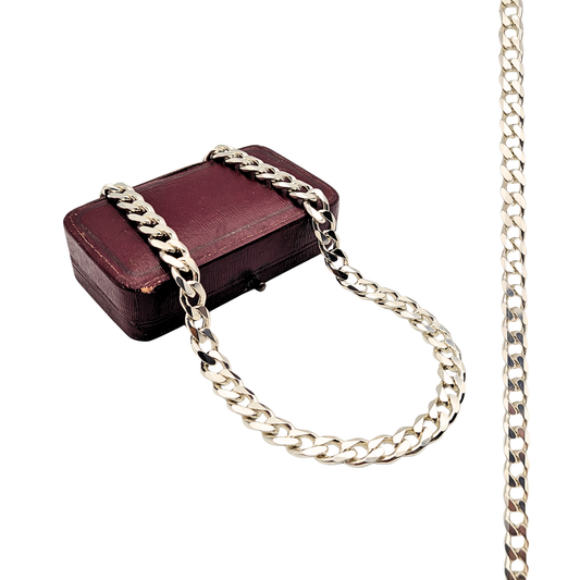 Close-up of an 18-inch sterling silver curb chain necklace, fully British hallmarked, with 7mm wide polished links and lobster clasp fastening, weighing 41.6g, refurbished to a mirror shine finish.