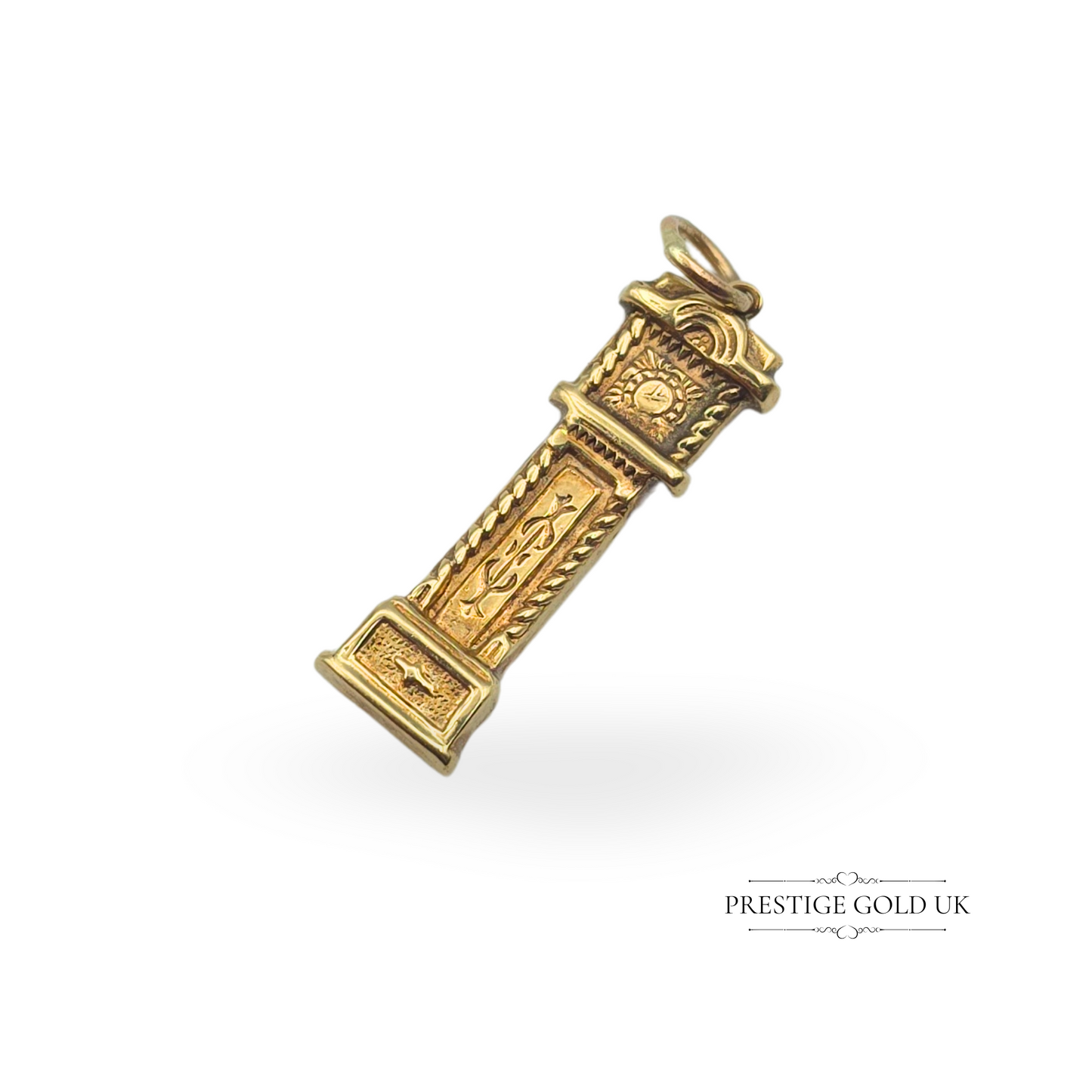 A vintage 9ct gold grandfather clock charm, hallmarked Birmingham 1972, featuring intricate engravings and a hollow construction. Measuring 25mm tall and weighing 1.1g, this detailed charm is a perfect addition to a gold charm bracelet or as a collectible pendant.