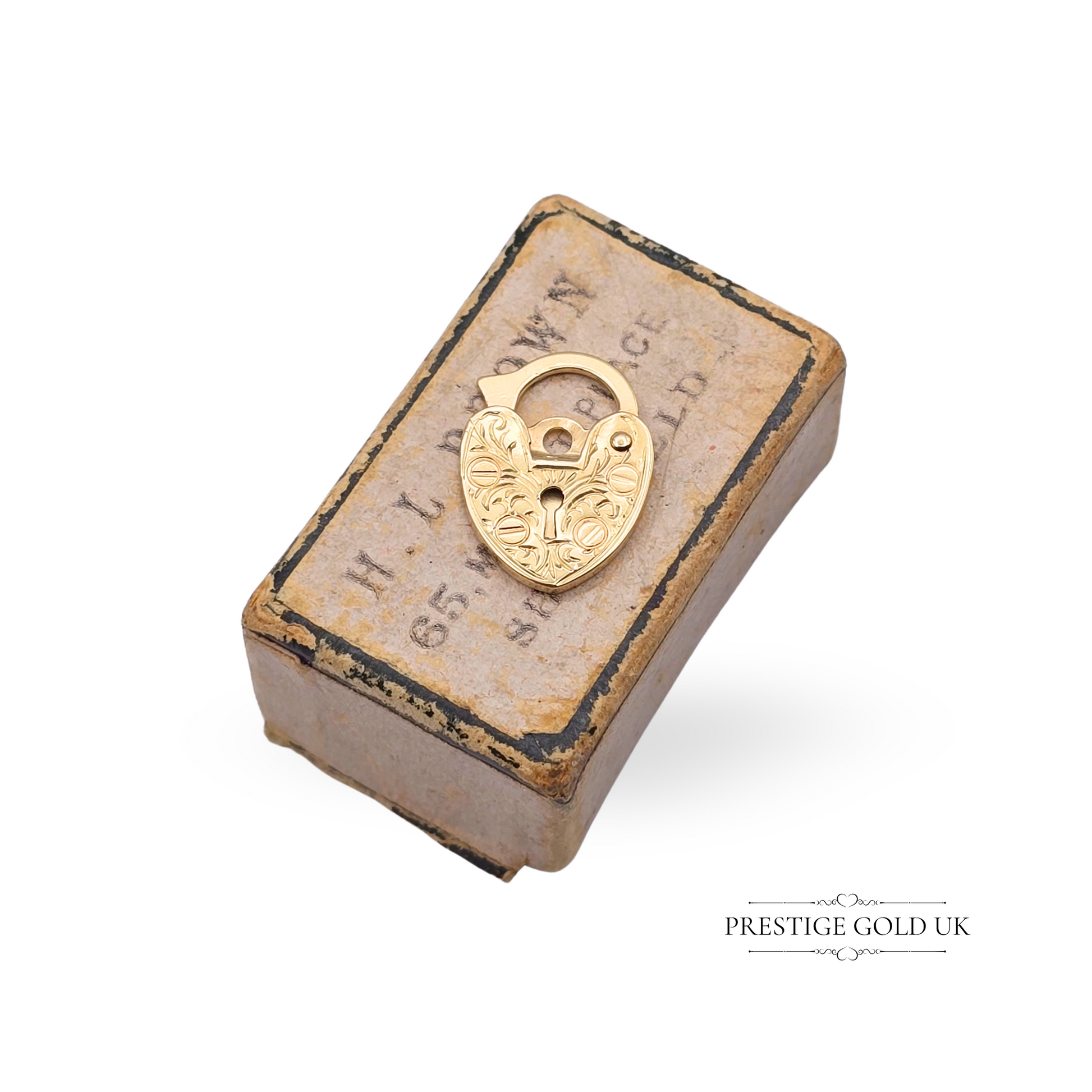 Tiny solid 9ct yellow gold heart-shaped padlock with hand-engraved front, flat 1mm design, working clasp mechanism, and 375 hallmark, 13mm tall.