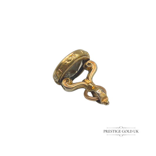 Tiny vintage 9ct gold wax seal fob featuring an engraved drinking birds design, perfect as a unique charm for a bracelet or pendant.