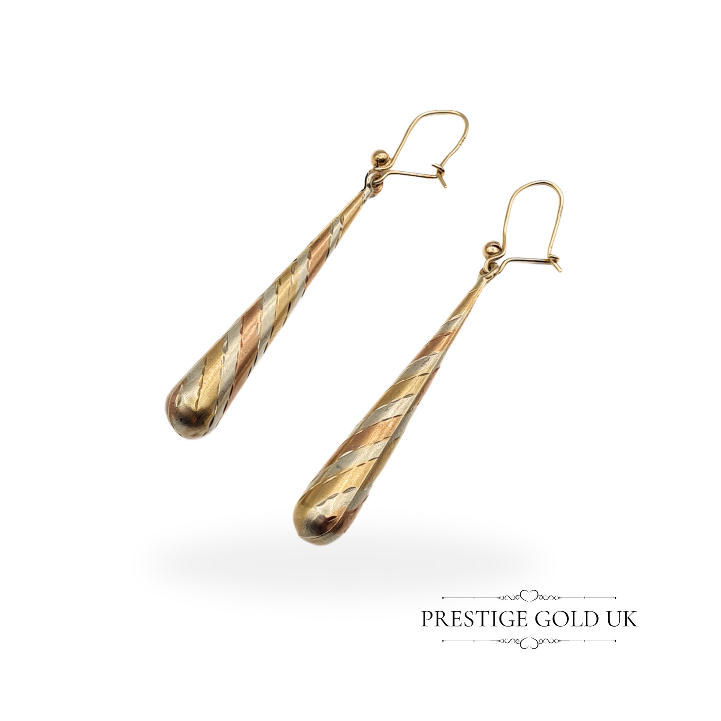 Close-up of vintage 9ct gold three-tone drop earrings with spiral design, showcasing yellow, white, and rose gold tones.