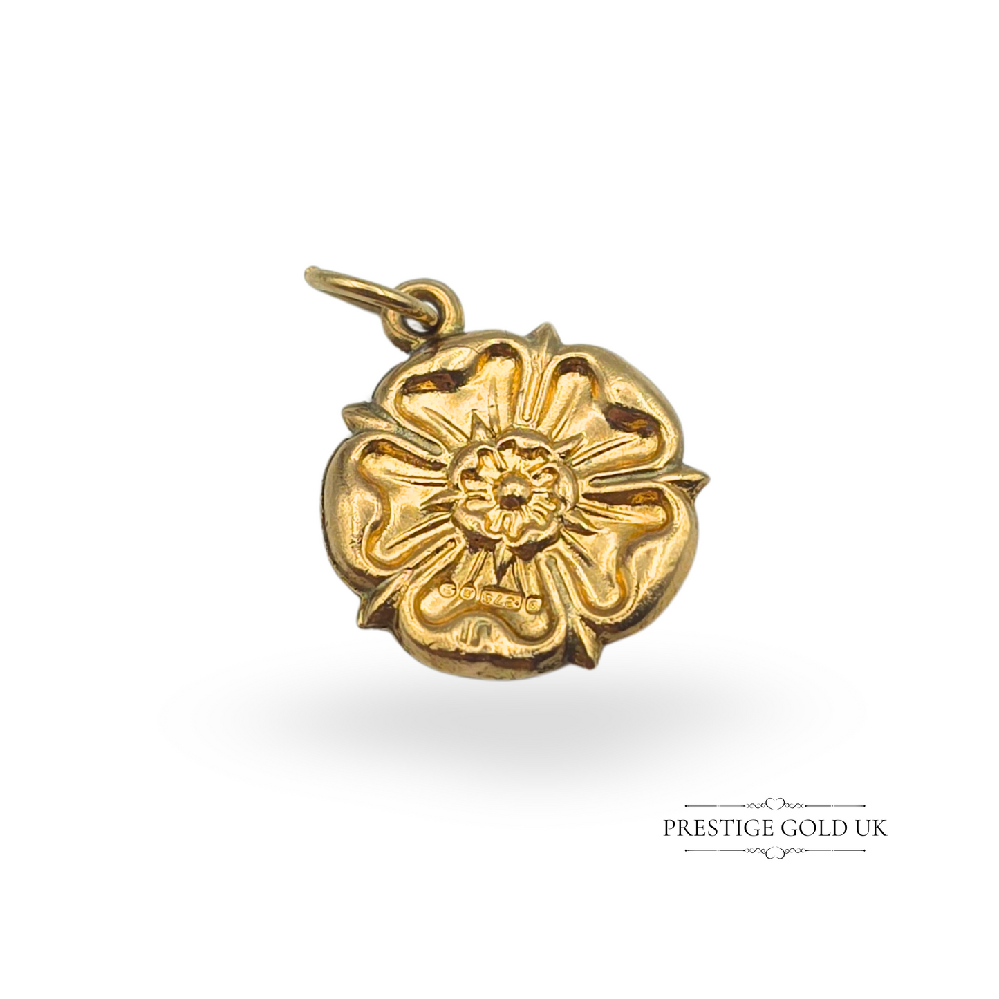 A vintage 9ct gold Yorkshire Rose charm with intricate floral detailing, measuring 14mm wide and 1.5mm deep. Fully hallmarked for London, 1968, this lightweight hollow gold charm features an open jump ring for easy attachment. A beautiful piece of English heritage jewellery, perfect for charm bracelets or necklaces.