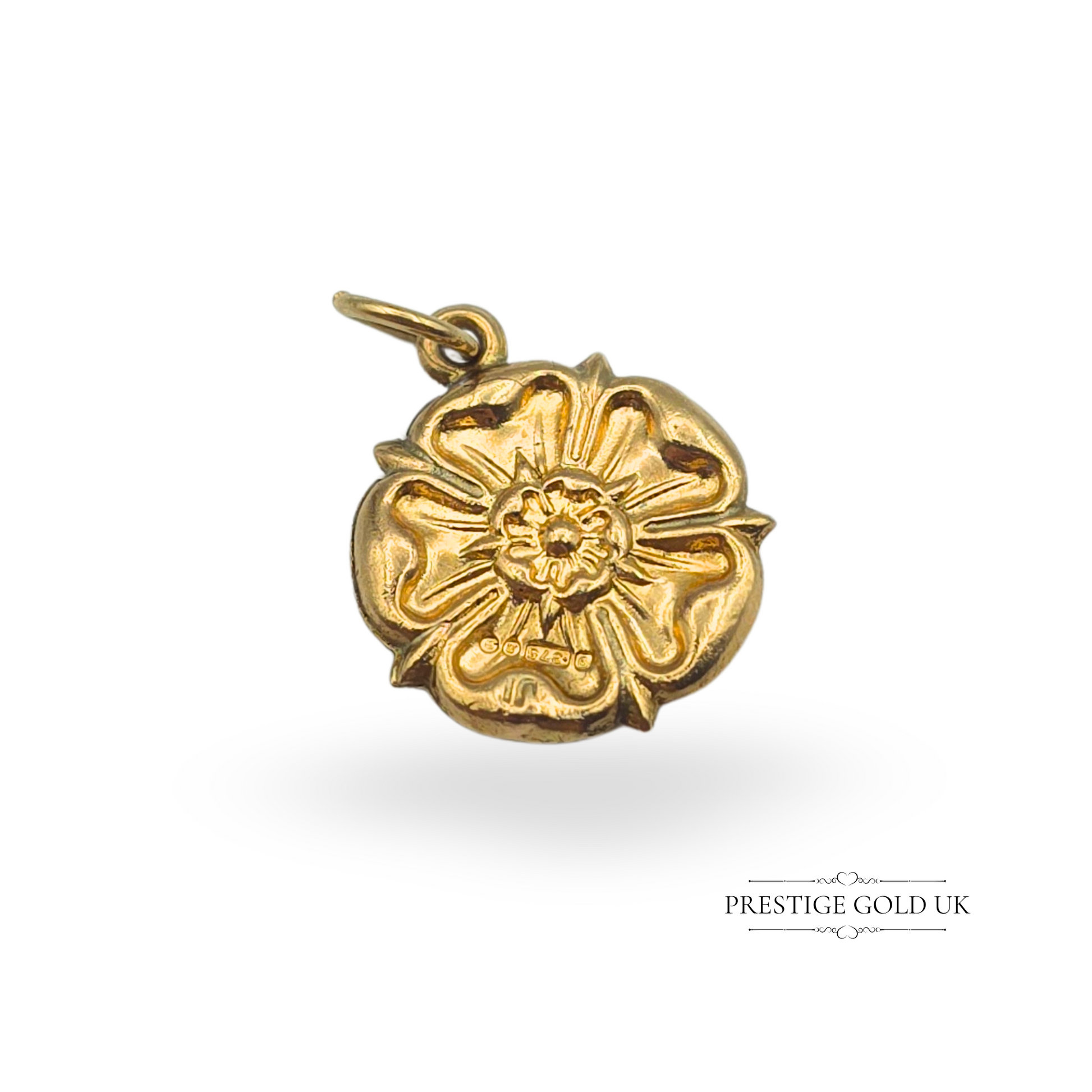 A vintage 9ct gold Yorkshire Rose charm with intricate floral detailing, measuring 14mm wide and 1.5mm deep. Fully hallmarked for London, 1968, this lightweight hollow gold charm features an open jump ring for easy attachment. A beautiful piece of English heritage jewellery, perfect for charm bracelets or necklaces.