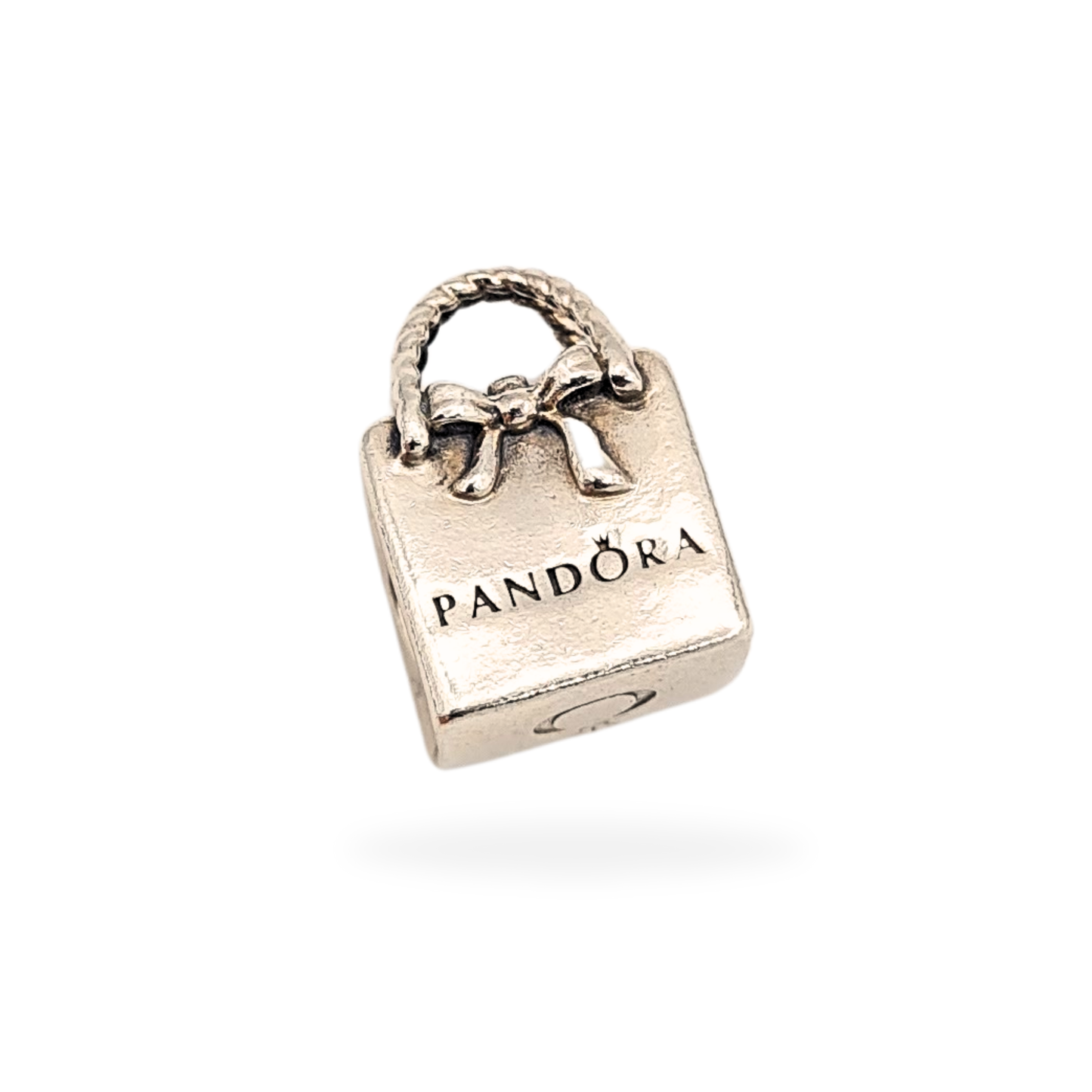 Authentic Pandora sterling silver Shopping Bag charm, style 791184, fully hallmarked S 925 ALE. Measures 14mm tall, 9mm wide and 8mm thick with rope-style handles and bow detail. Excellent polished condition, fits Pandora Moments bracelets.