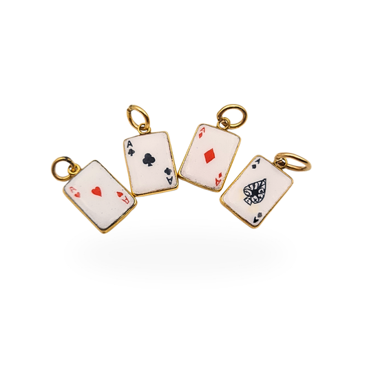 Set of four 9ct gold playing card charms featuring enamelled Ace of Hearts, Clubs, Diamonds and Spades, hallmarked Birmingham 1987. Each miniature card measures 10mm by 8mm and is fully hallmarked, forming a petite vintage poker-themed charm collection.
