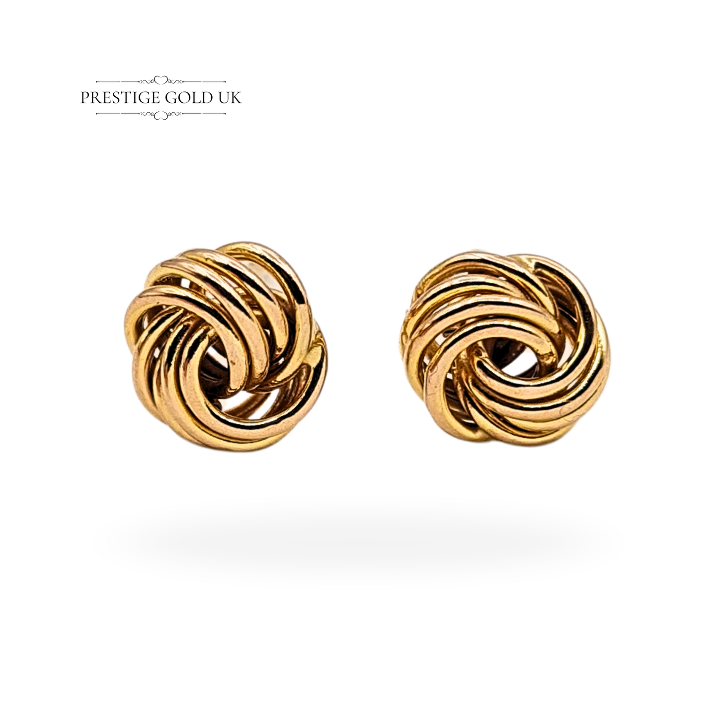 Pair of small 9ct yellow gold Woolmark knot stud earrings with secure butterfly backs, stamped 375 and fully tested, featuring 7mm rounded faces with interlaced loops in a vintage design, photographed by Prestige Gold UK on antique props.