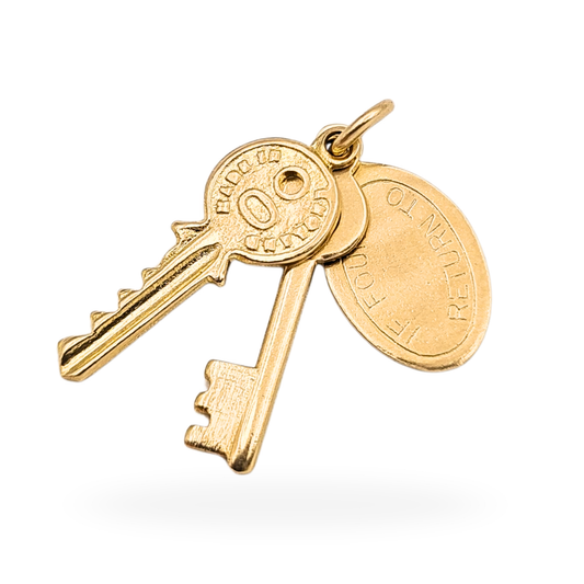Photograph of a 9ct gold charm featuring two miniature keys and an oval tag engraved “If Found Please Return To.” Fully hallmarked Birmingham 1960, 20mm x 8mm, 1.20g solid gold pendant ideal for vintage jewellery collectors or sentimental gifts.