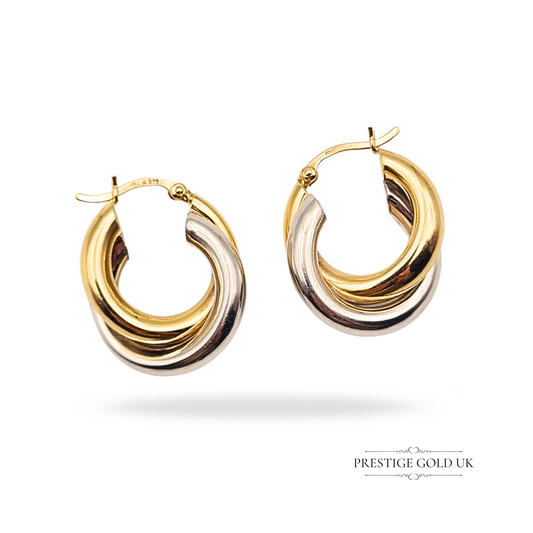 9ct gold interlocking hoop earrings in two tone design, yellow and white gold, London hallmark, weighing 4.03g, measuring 24mm tall by 9mm wide, chunky twisted hoop style with secure flip-top fasteners, bold statement earrings.
