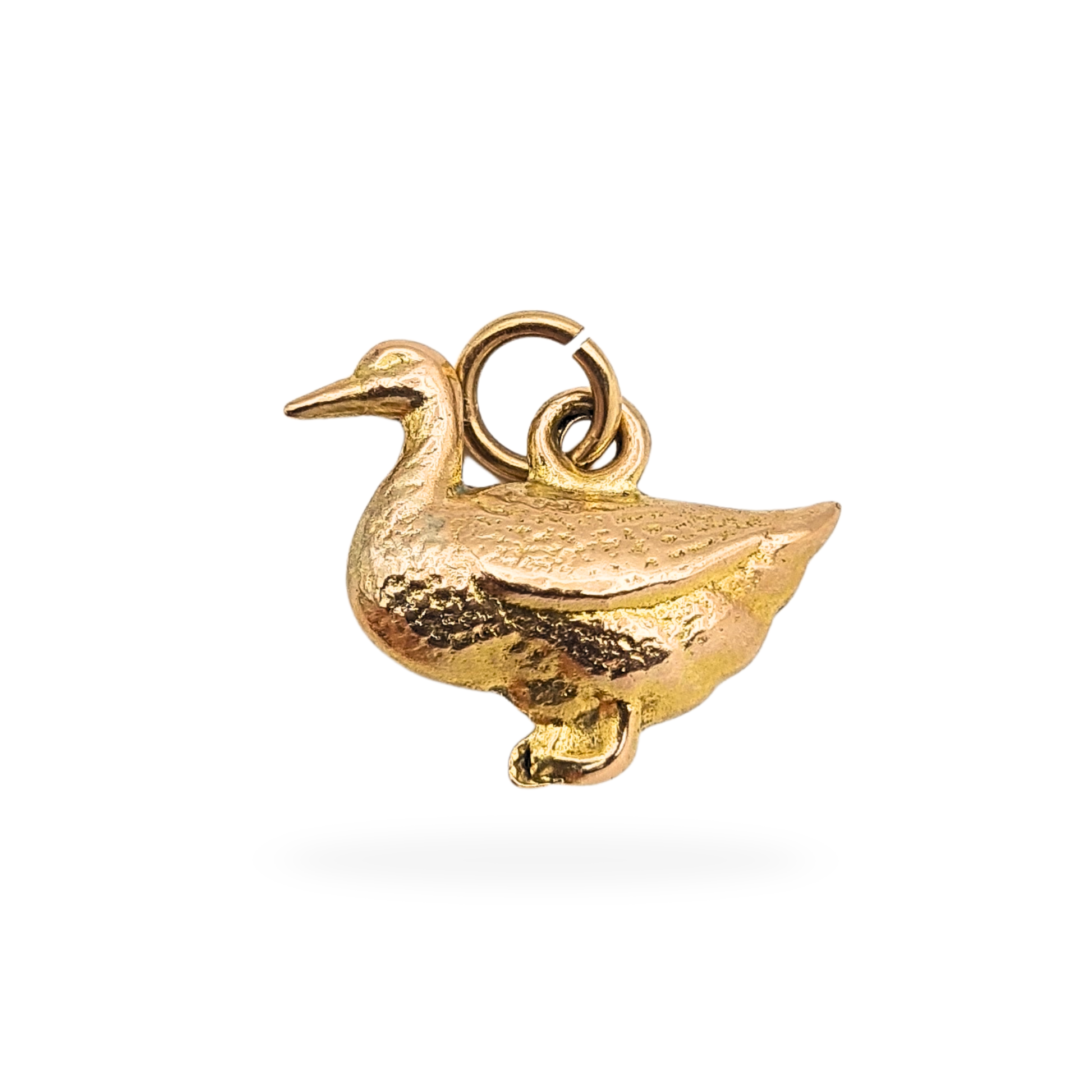 Small 9ct gold puffy duck charm measuring 17mm long, 14mm tall and 4mm wide, hollow construction and weighing 0.7g. Not hallmarked but fully tested as 9ct gold, with textured feather detail and polished finish, shown with scale and close-up images.