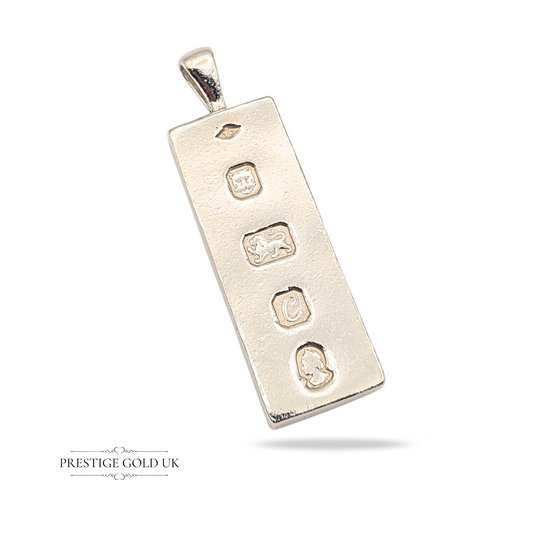 Large 925 sterling silver ingot pendant with London hallmark dated 1977, 53mm tall, 16mm wide, weighing 26.78 grams, featuring maker's mark, lion passant, date letter, and assay office stamps, smooth edges and polished finish.