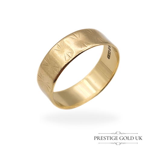 A vintage 9ct gold ring featuring an intricate star-patterned design on a flat-sided band, fully hallmarked in London, 1964.
