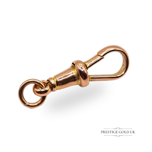Close-up image of an antique 9ct rose gold dog clasp swivel hook, 25mm long by 7mm wide, weighing 1.83g, stamped 9ct, for use with Albert chains or vintage jewellery repairs.
