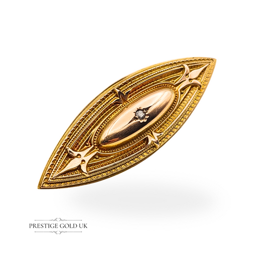 Antique 9ct gold mourning brooch in marquise shape with a single diamond accent, intricate Gothic detailing, and a hidden locket compartment. Tested gold with a base metal pin and hinged clasp, 48mm long, Victorian style.