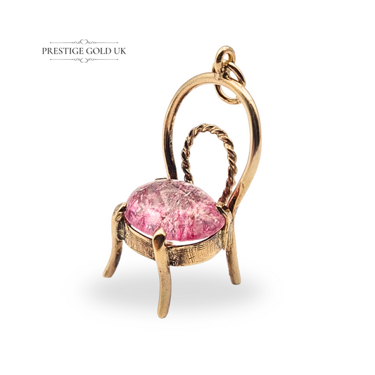 9ct gold chair pendant with twisted backrest design, featuring a pink crystal cushion seat, fully tested (not hallmarked), measuring 25mm tall by 14mm wide and 10mm deep, weighing 2.57g, unique collectible charm.
