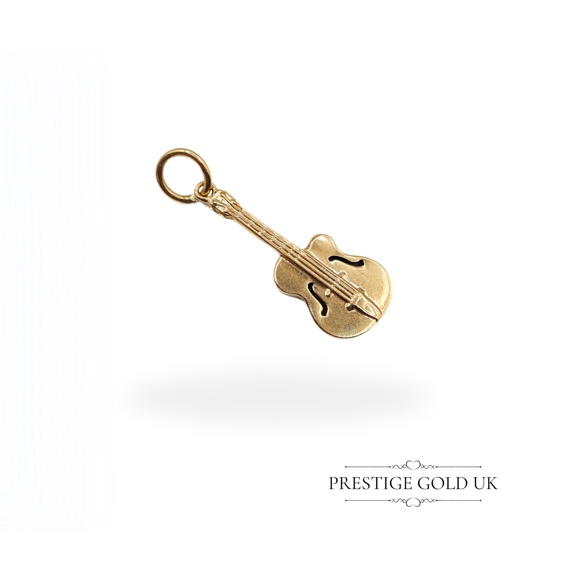 Vintage 9ct gold guitar charm with intricate details, fully hallmarked for Birmingham, displayed on a white background.