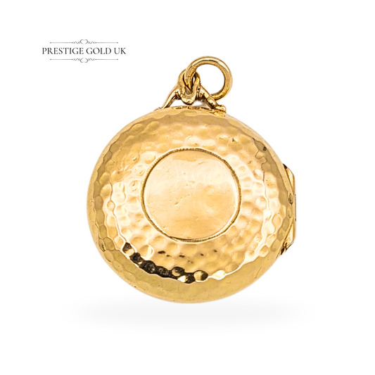 Antique 9ct gold round locket with hammered texture, hallmarked Birmingham 1928. Measures 20mm in diameter and 6mm deep, weighing 2.85g. Opens to hold two small photos, with a secure clasp and elegant antique finish — a classic British gold keepsake.