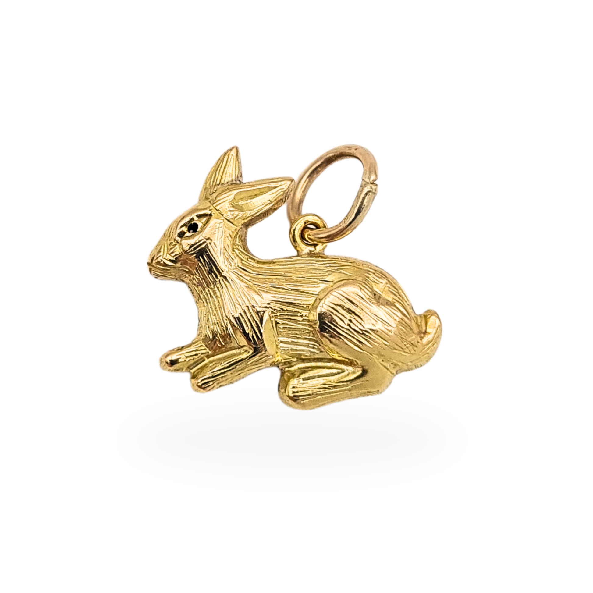 Petite 9ct gold rabbit charm pendant measuring 14mm long, 13mm tall and 5mm wide, crafted in hollow puffy construction with engraved fur detail. Fully tested gold with no hallmark, lightweight at 1.2g and ideal for bracelet or necklace wear.
