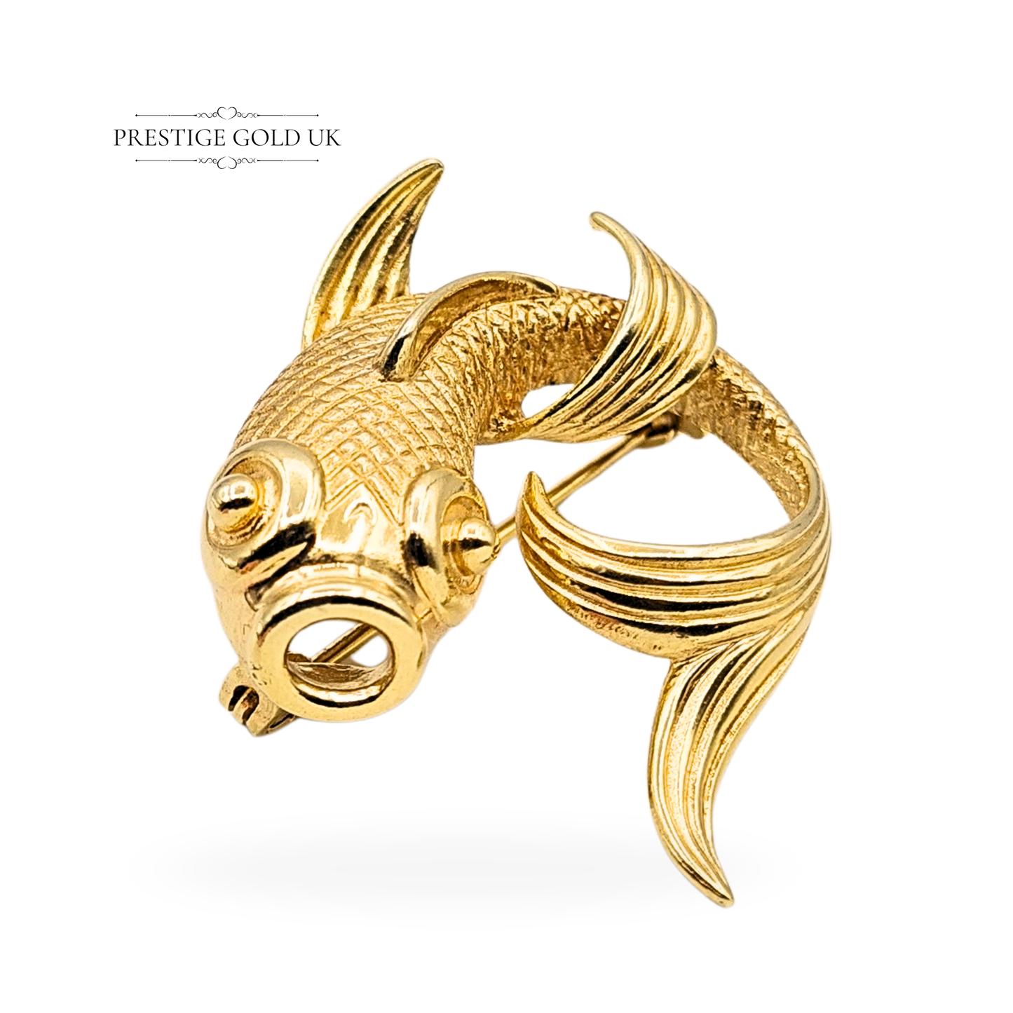 Solid 9ct gold koi carp brooch with London 1977 import hallmark, weighing 6.7g and measuring 23mm x 30mm. Ornate sculpted fish design with flowing fins and detailed scales, secure locking clasp, vintage statement gold pin.