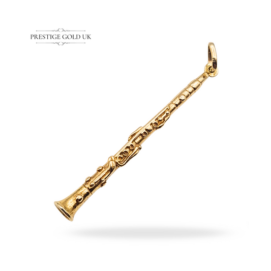 Large 9ct gold clarinet or oboe pendant, fully hallmarked, weighing 4.58g, measuring 52mm long with detailed keywork, a heavy musical jewellery charm ideal for musicians or collectors, crafted in solid gold.