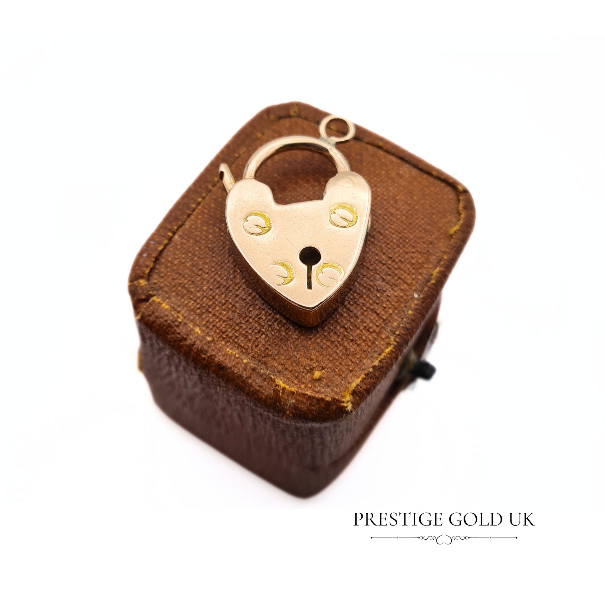    Vintage 9ct yellow gold heart padlock charm, featuring a chunky design and weighing 2.7 grams, ideal as a jewellery clasp or pendant.