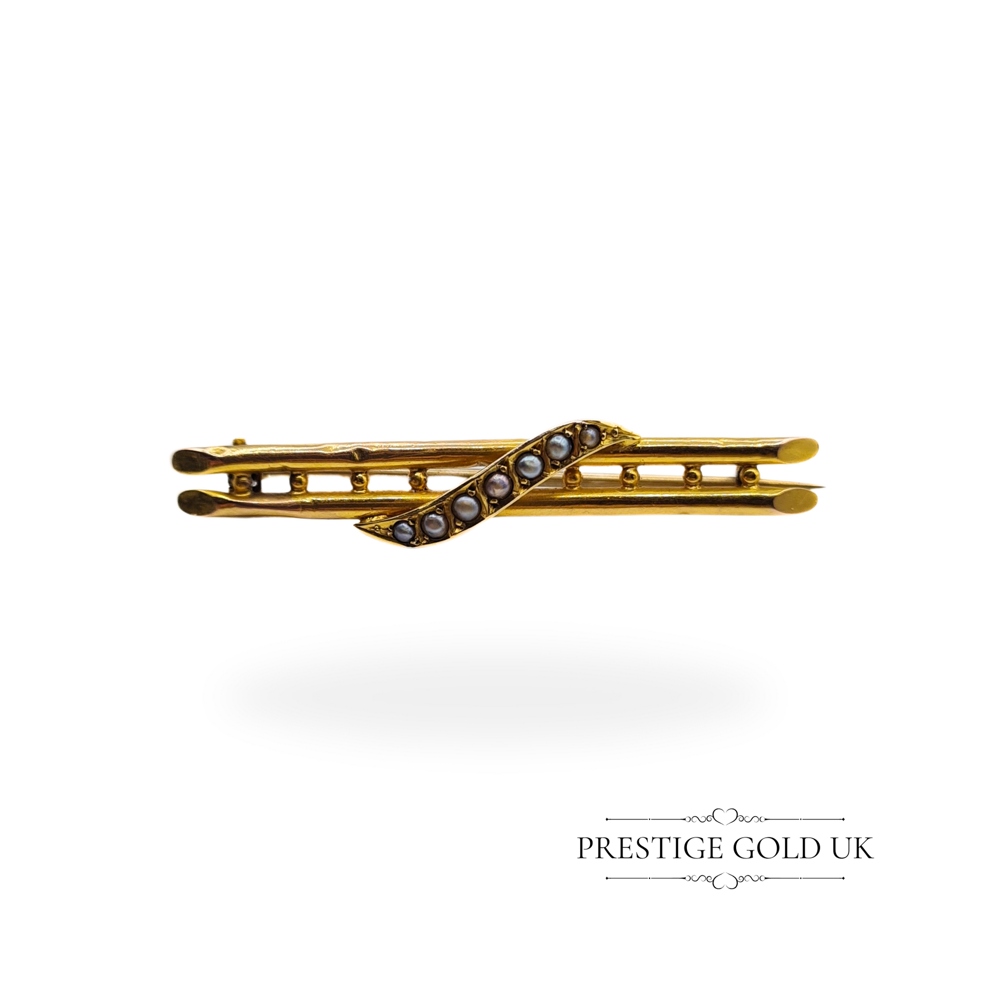     Vintage twin-row brooch crafted in 9ct hollow gold, featuring a swirl of seed pearls, 4.5cm long.