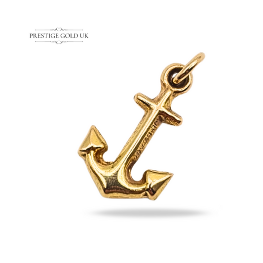 Vintage 9ct gold anchor charm, hallmarked London 1964. Measuring 16mm long, 10mm wide, and 3mm deep, weighing 0.72 g. Hollow construction with polished finish, a collectible maritime gold pendant or charm for bracelet or necklace.
