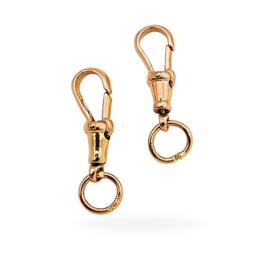Pair of vintage 9ct rose gold dog clips with jump rings, fully British hallmarked, weighing 3.32g total, measuring 21mm long (27mm including rings), secure spring clasps ideal for Albert chains, pocket watches, or necklace conversions.